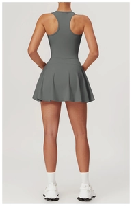 Detail of racerback design and pleated hem on a dark grey athletic tennis dress