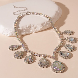 Detailed macro view of silver-tone teardrop pendant with rainbow crystal and pavé rhinestones