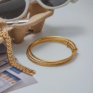 Detailed view of triple-layered gold zircon bracelet and chain in stylish setup