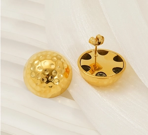 Detailed macro view of 18K gold-plated stainless steel stud earrings with hammered texture