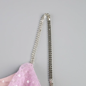 Détail du tissu en maille lilas avec paillettes argentées et bretelles en strass brillants