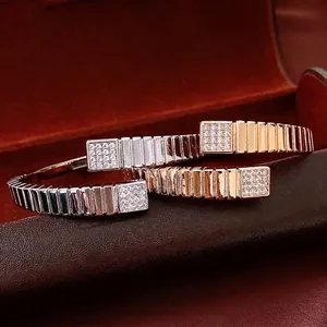 Three square cuff bracelets in gold, silver, and rose gold with pavé zircon accents