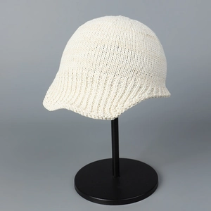 Close-up detail of white knitted aviation hat showing breathable texture