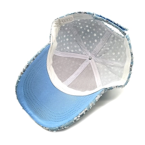Detail view of the blue sequin baseball cap interior with breathable mesh and sweatband