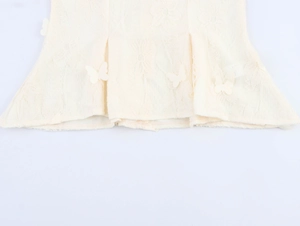 Detail of floral lace fabric with 3D butterfly embroidery and square neckline puff sleeves
