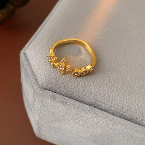 Macro detail of vintage gold star flower ring with sparkling zircon stones