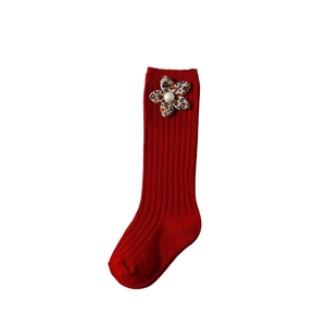 Red knit long baby socks with 3D floral and pearl accents on a clean white background