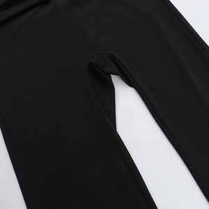 Detailed close-up showing the smooth knitted fabric and neat seams of black leggings