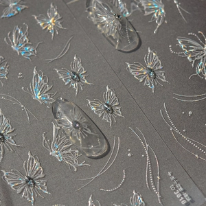 Detailed macro view of 3D embossed holographic butterfly nail art stickers with laser effects
