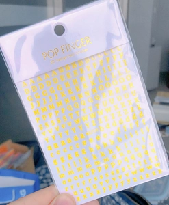 Detailed view of WG719 gold 3D nail stickers featuring elegant alphabet letters
