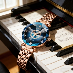 Women's rose gold watch with blue starry dial on piano keys, luxury faceted crystal face