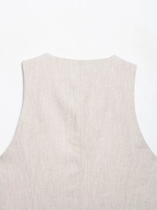 Close-up of oatmeal vest showing neck tailoring and fine fabric texture on back seam