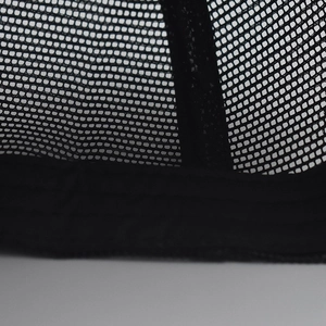 Macro shot of breathable black mesh fabric with reinforced stitching on baseball cap