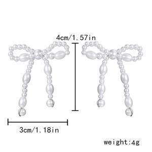 Detailed view of pearl bow earrings with size measurements of 4cm height and 3cm width