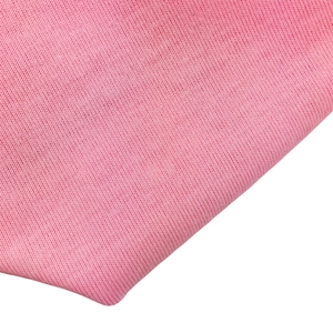 Close-up of pink knitted cotton fabric texture on a soft baby turban hat