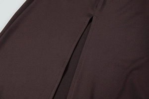Macro detail of side slit stitching on a dark brown textured knit dress fabric