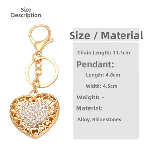 Detail view of heart-shaped hollow keychain with shiny rhinestones and golden lobster clasp