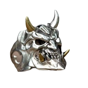 Gothic Prajna mask ring in silver and gold with horn and skull details on white back