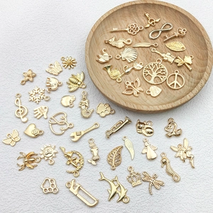 Macro shot of assorted KC gold alloy charms with musical notes and mermaid patterns