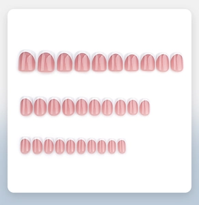 Detail of short French tip press-on nails set with pink base and white edges