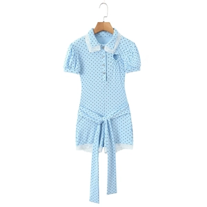 Detail of light blue polka dot romper with lace trim and heart-shaped cutout design