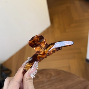 Elegant tortoiseshell acetate hair claw clip with gold label for high ponytail