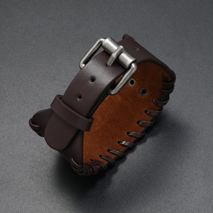 Detail of wide dark brown woven leather bracelet with vintage metal buckle and texture