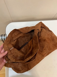 Interior detail of vintage brown faux suede tote bag featuring floral embroidery and lining