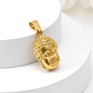 Macro view of polished 18K gold stainless steel Buddha pendant on white display pedestal