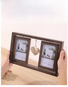 Detail of a rotating brown wood photo frame with a heart-shaped World's Best Dog Mom charm
