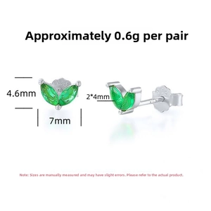 Macro shot of S925 sterling silver leaf stud earrings with green marquise zircon stones