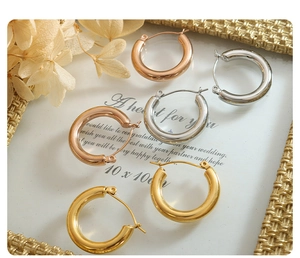 Detailed close-up of classic hoop earrings in gold, silver and rose gold finishes