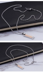 Macro detail of silver and rose gold square pendant with Love devotion engraving