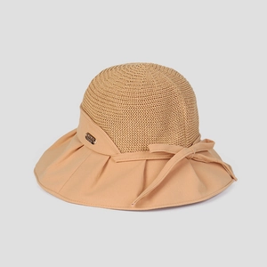 Detail of summer sun hat featuring breathable straw weave and a sweet bow decoration