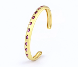 Detailed side view of 18k gold plated cuff bangle with oval pink zircon stones