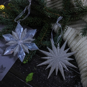 Sparkling transparent snowflake and star ornaments with silver glitter and white ribbons