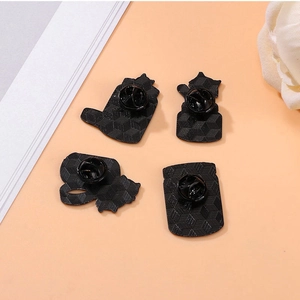 Back view of four cat animal enamel pins with black clutch and textured metal surface