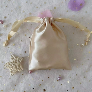 Champagne gold satin drawstring pouch bag with glossy silk texture for gift packaging