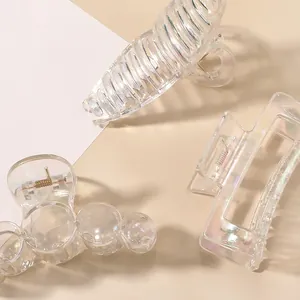 Macro detail of transparent iridescent hair claws with shimmering pearlescent finish