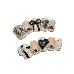Nude and black handmade press-on nails with 3D bows, rhinestones and heart accents