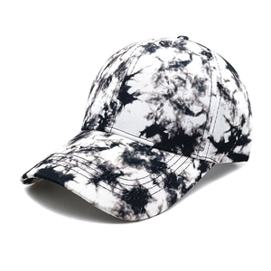 Detail of black and white tie-dye baseball cap with marble texture and reinforced stitching
