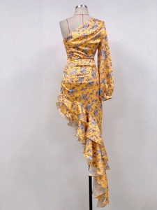 Detail of yellow floral satin dress with asymmetrical ruffled hem and off-shoulder design