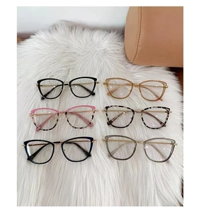 Selection of six cat-eye glasses frames in assorted colors on a soft white texture