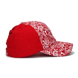 Detail of red paisley print baseball cap with cross ponytail hole and cotton texture