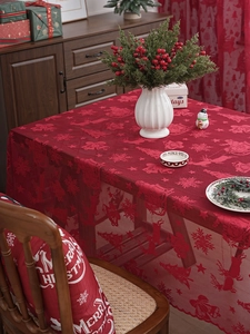 Close-up of red Christmas lace tablecloth featuring snowflake and reindeer patterns