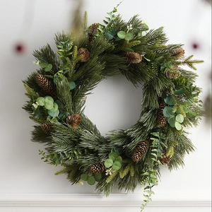 Green Christmas wreath with pine needles, cones and eucalyptus on white background