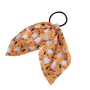 Halloween scrunchie with orange ribbon featuring ghost, pumpkin, and bat patterns