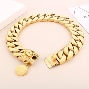 Detailed view of bold golden Cuban chain collar for large dogs with polished metal finish