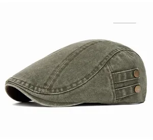 Detail of washed olive green cotton beret featuring two vintage bronze metal side buttons