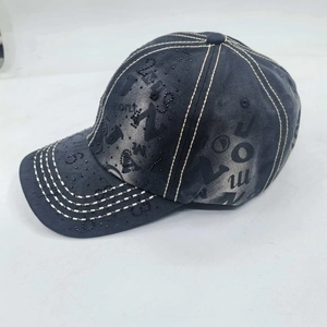 Detailed view of the dark grey washed denim baseball cap with bead embroidery and contrast stitching